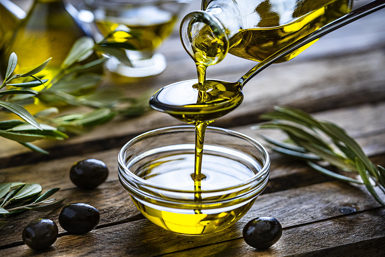 Pouring extra virgin olive oil in a glass bowl | olive oil around Highlands Ranch