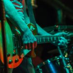 man playing a guitar on a stage | music venues Highlands Ranch